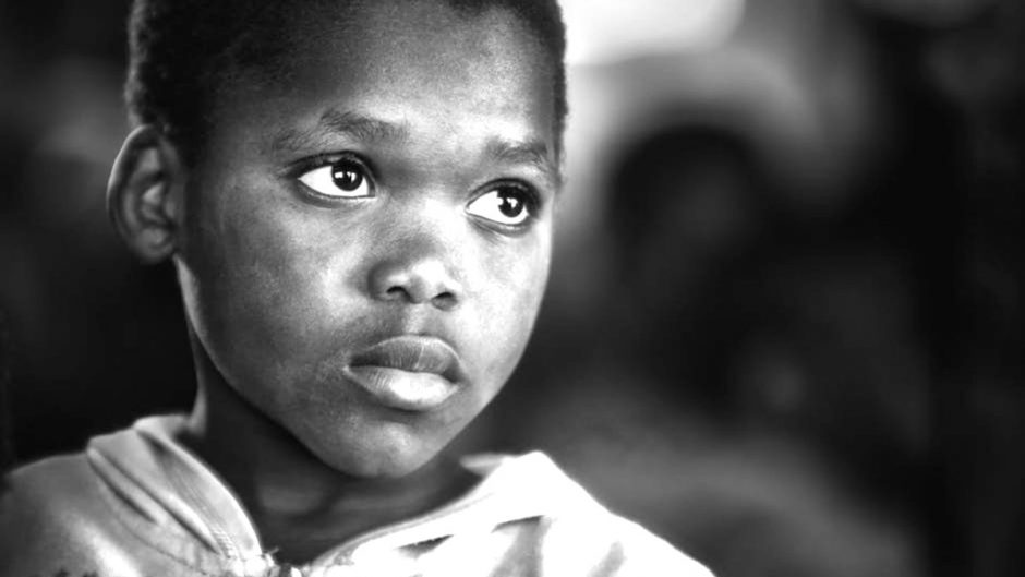 African american kid gazing up wondering about a future life in the sales lane