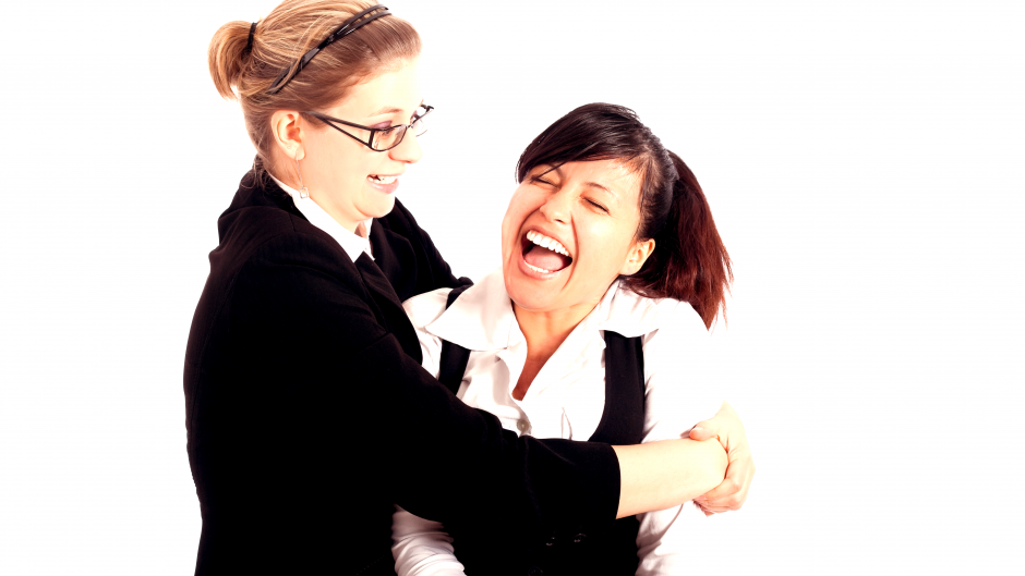 Two young happy business women funny moment, isolated on white background celebrating in the sales Lane