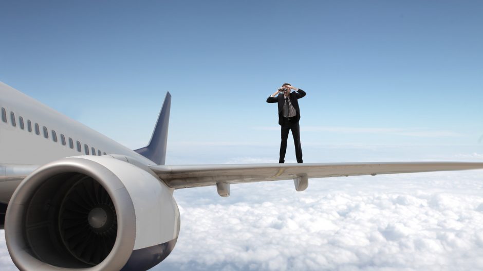 Business man practicing lead generation on airplane wing