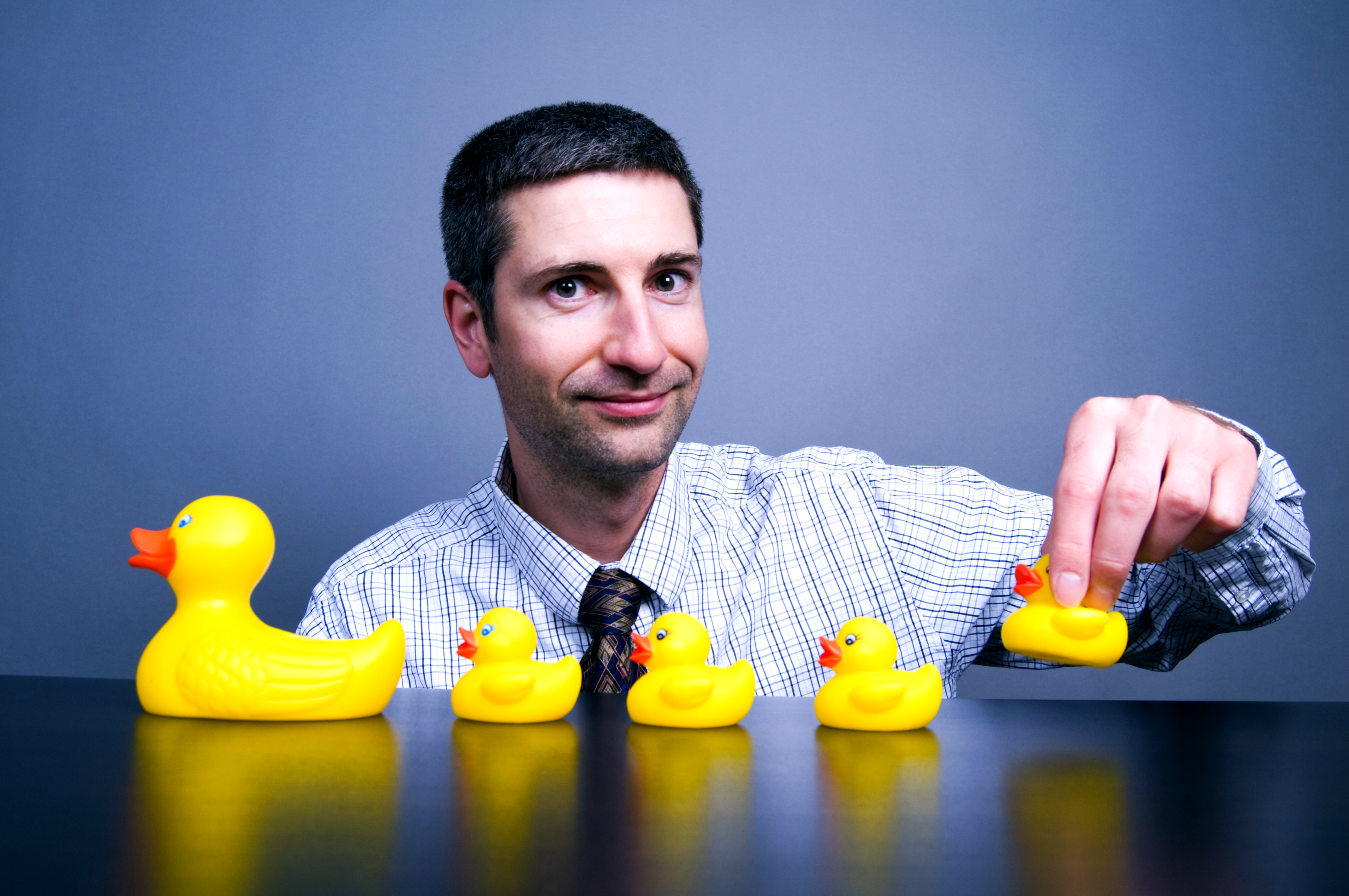 Man pondering life in the sales lane with yellow rubber duckies 